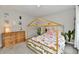 room with a low canopy bed, rainbow bedding, cactus decals and a chest of drawers at 3872 New Battle Ln, Bargersville, IN 46106