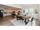 Open-concept dining room with a wooden table, view of the kitchen, and natural light at 3872 New Battle Ln, Bargersville, IN 46106