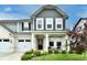Charming home exterior with a well-manicured lawn, inviting front porch, and a three-car garage at 3872 New Battle Ln, Bargersville, IN 46106