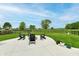 Backyard with a fire pit surrounded by Adirondack chairs on concrete patio at 3872 New Battle Ln, Bargersville, IN 46106