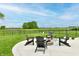 Backyard with a fire pit surrounded by Adirondack chairs on concrete patio at 3872 New Battle Ln, Bargersville, IN 46106