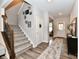 Inviting foyer with staircase, wood floors, neutral paint, and stylish decor at 3872 New Battle Ln, Bargersville, IN 46106