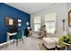 Bright home office with blue wall, large windows, reading chair and ottoman at 3872 New Battle Ln, Bargersville, IN 46106