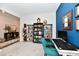 Well-lit home office with a blue accent wall, complete with a stylish desk and carpeted floor at 3872 New Battle Ln, Bargersville, IN 46106