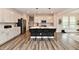 Bright, modern kitchen with white cabinets, a large island, and black bar stools at 3872 New Battle Ln, Bargersville, IN 46106