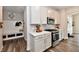 This modern kitchen is bright with white cabinets, stainless appliances, and wood floors at 3872 New Battle Ln, Bargersville, IN 46106