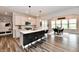 Open-concept kitchen with a large island, modern lighting, and view of the dining room at 3872 New Battle Ln, Bargersville, IN 46106