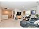Upstairs living room featuring large television, comfortable seating, and neutral carpeting at 3872 New Battle Ln, Bargersville, IN 46106