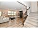 Cozy living room with large sectional sofa, fireplace, and stairwell at 3872 New Battle Ln, Bargersville, IN 46106