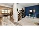 Inviting office space with stylish decor, shelving, and comfortable seating adjacent to living room at 3872 New Battle Ln, Bargersville, IN 46106