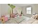 Vibrant playroom featuring a cozy couch, a play area, a tree mural, and natural light, perfect for  at 3872 New Battle Ln, Bargersville, IN 46106