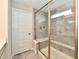 Walk-in shower with gray tile, a glass door and side panel, a built-in bench, and a hand-held sprayer at 3872 New Battle Ln, Bargersville, IN 46106