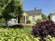 Charming yellow home with a well-manicured lawn and mature trees in a desirable neighborhood at 407 N Alton Ave, Indianapolis, IN 46222