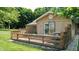 Backyard deck with greenery, painted railing, and sliding door access at 4124 Five Points Rd, Indianapolis, IN 46239