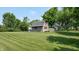 Barn on manicured lawn with mature trees at 4124 Five Points Rd, Indianapolis, IN 46239