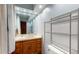 Well-lit bathroom with vanity, mirror, and metal shelving at 4124 Five Points Rd, Indianapolis, IN 46239