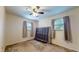 Bright bedroom featuring two windows and a ceiling fan at 4124 Five Points Rd, Indianapolis, IN 46239