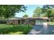 Exterior of home with brick facade, attached garage, and driveway at 4124 Five Points Rd, Indianapolis, IN 46239