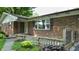 Front entrance with a brick facade, decorative plants, and handicap access at 4124 Five Points Rd, Indianapolis, IN 46239