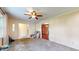 Spacious living room featuring neutral carpet and a ceiling fan at 4124 Five Points Rd, Indianapolis, IN 46239