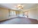 Bright living room features large window, ceiling fan, and sliding glass doors at 4124 Five Points Rd, Indianapolis, IN 46239