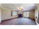 Large living room features a brick fireplace and sliding glass doors to the outside at 4124 Five Points Rd, Indianapolis, IN 46239