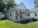Charming home features a welcoming front porch perfect for enjoying the outdoors and a tidy, landscaped front yard at 420 S Oak St, Fortville, IN 46040