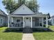 Charming home features a welcoming front porch perfect for enjoying the outdoors and a tidy, landscaped front yard at 420 S Oak St, Fortville, IN 46040