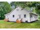 This backyard boasts a well-maintained exterior with multiple entrances, wooden steps, and green landscaping at 4255 N County Road 1025 E, Indianapolis, IN 46234