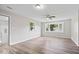 Bright bedroom with a ceiling fan, hardwood floors, and large window at 4255 N County Road 1025 E, Indianapolis, IN 46234