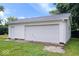 A detached garage features a white exterior with a large garage door and side entrance at 4255 N County Road 1025 E, Indianapolis, IN 46234