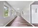 Bright hallway featuring wood-look floors, fresh neutral paint, and multiple windows offering natural light at 4255 N County Road 1025 E, Indianapolis, IN 46234