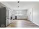 Modern white kitchen with stainless steel appliances, hardwood floors and updated cabinets at 4255 N County Road 1025 E, Indianapolis, IN 46234