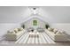 Bright living room in the attic with neutral paint, carpet, stylish furniture and large windows at 4255 N County Road 1025 E, Indianapolis, IN 46234