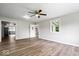 Spacious living room featuring hardwood floors, neutral paint, and a view to other rooms at 4255 N County Road 1025 E, Indianapolis, IN 46234