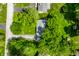 A high-angle shot of a cozy home with a well-kept lawn, surrounded by mature trees in a peaceful residential area at 4275 Springwood Trl, Indianapolis, IN 46228