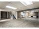 Unfinished basement featuring tile floors, staircase, laundry area, and a work bench at 4275 Springwood Trl, Indianapolis, IN 46228