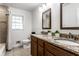 Bathroom featuring dual sinks, framed mirrors, granite countertops, and a tiled shower/tub at 4275 Springwood Trl, Indianapolis, IN 46228