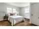 Bright bedroom featuring hardwood floors, two windows and matching nightstands with lamps at 4275 Springwood Trl, Indianapolis, IN 46228