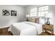 Bedroom featuring hardwood floors, art on the wall and matching nightstands with lamps at 4275 Springwood Trl, Indianapolis, IN 46228