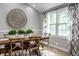 Charming dining room featuring a wooden table, decorative wall art, and plenty of natural light from windows at 4275 Springwood Trl, Indianapolis, IN 46228