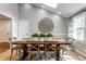 Bright dining room boasts a vaulted ceiling, a skylight, and a rustic wooden table with seating for six at 4275 Springwood Trl, Indianapolis, IN 46228