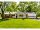Charming single story brick home with an attached garage and a covered front porch at 4275 Springwood Trl, Indianapolis, IN 46228