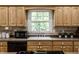 Classic kitchen design featuring neutral countertops, light wood cabinetry, and stainless steel appliances at 4275 Springwood Trl, Indianapolis, IN 46228