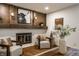 Living room with a fireplace and mantel, with hardwood flooring and modern decor at 4275 Springwood Trl, Indianapolis, IN 46228