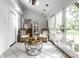 Relaxing sunroom featuring wicker chairs, a skylight, and doors leading to a serene outdoor space at 4275 Springwood Trl, Indianapolis, IN 46228