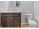 Bathroom features a wooden vanity with modern countertop and a toilet at 450 N Fenton Ave, Indianapolis, IN 46219