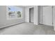 Bedroom featuring plush carpet, a window for ample natural light and an open closet at 450 N Fenton Ave, Indianapolis, IN 46219