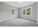 Bright bedroom featuring plush carpet, two large windows for ample natural light and neutral decor at 450 N Fenton Ave, Indianapolis, IN 46219