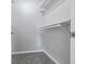 Walk-in closet featuring plush carpet, fresh, neutral wall color and a built-in hanging rack at 450 N Fenton Ave, Indianapolis, IN 46219